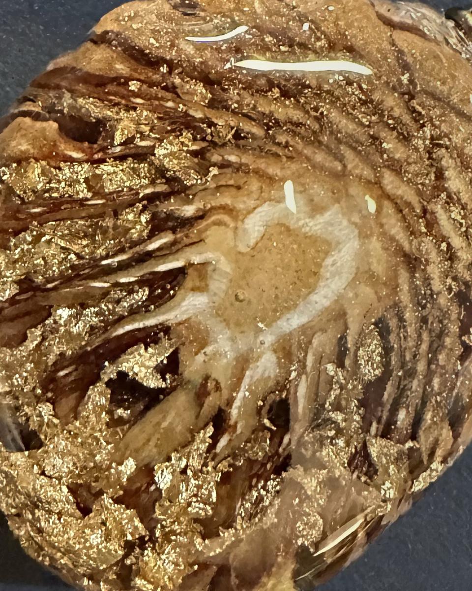 Close view of the gold flakes over the spiral of scales