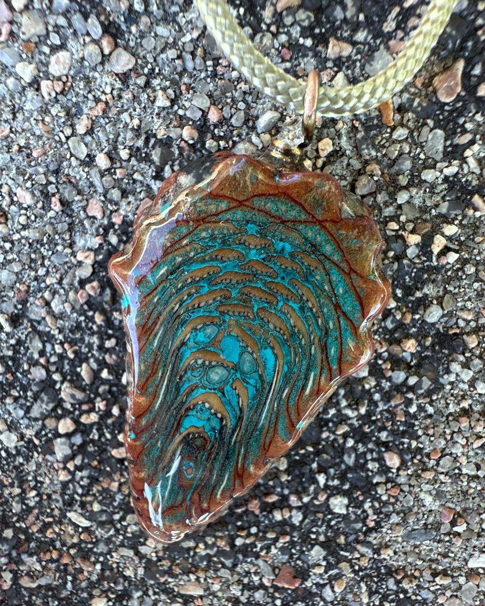 Close view of one face, with arcs of rust-edged scales over turquoise